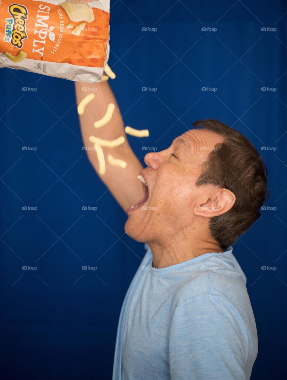 Man devouring Cheetos 