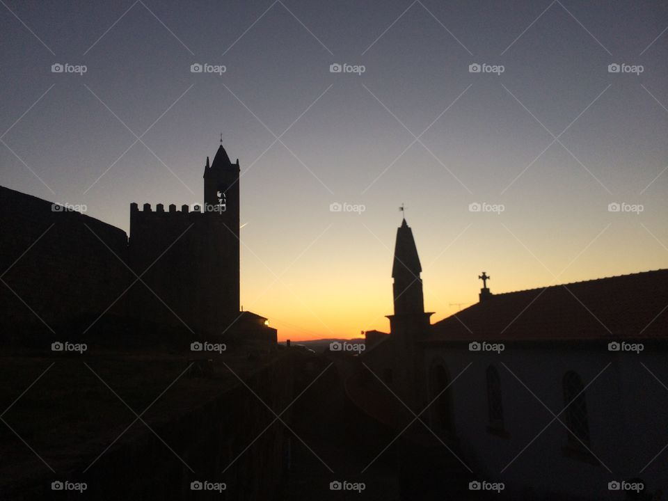 Sunset in Penamacor. Castle and church silhouette.
