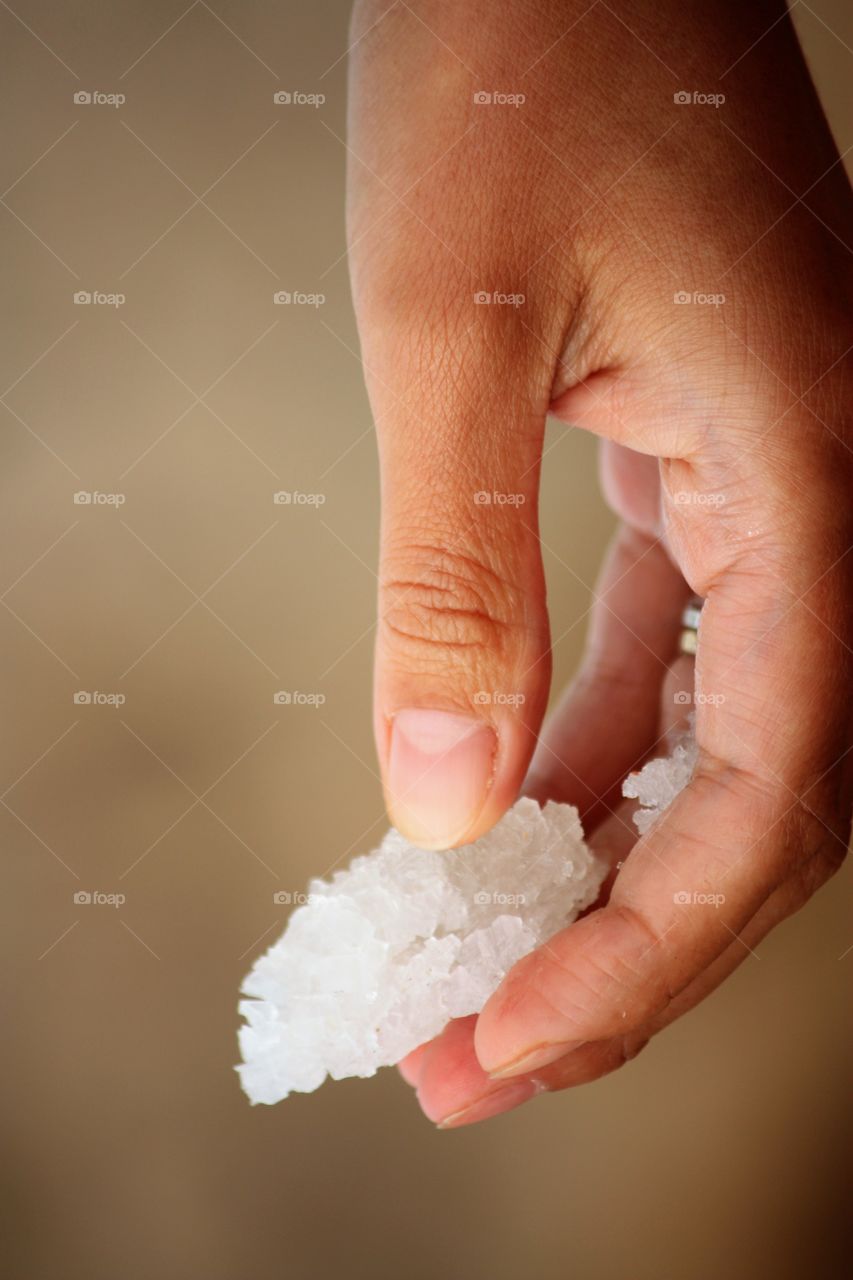Close-up of child's hand picking the Salt