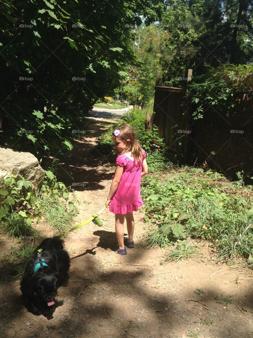 Little girl with black dog
