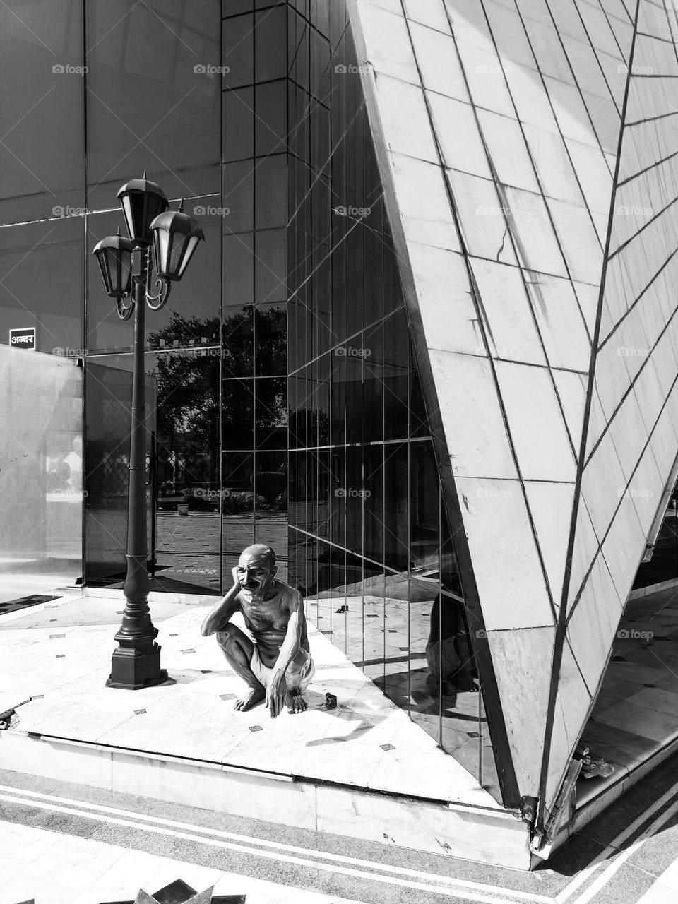 black and white architecture with statue in front.