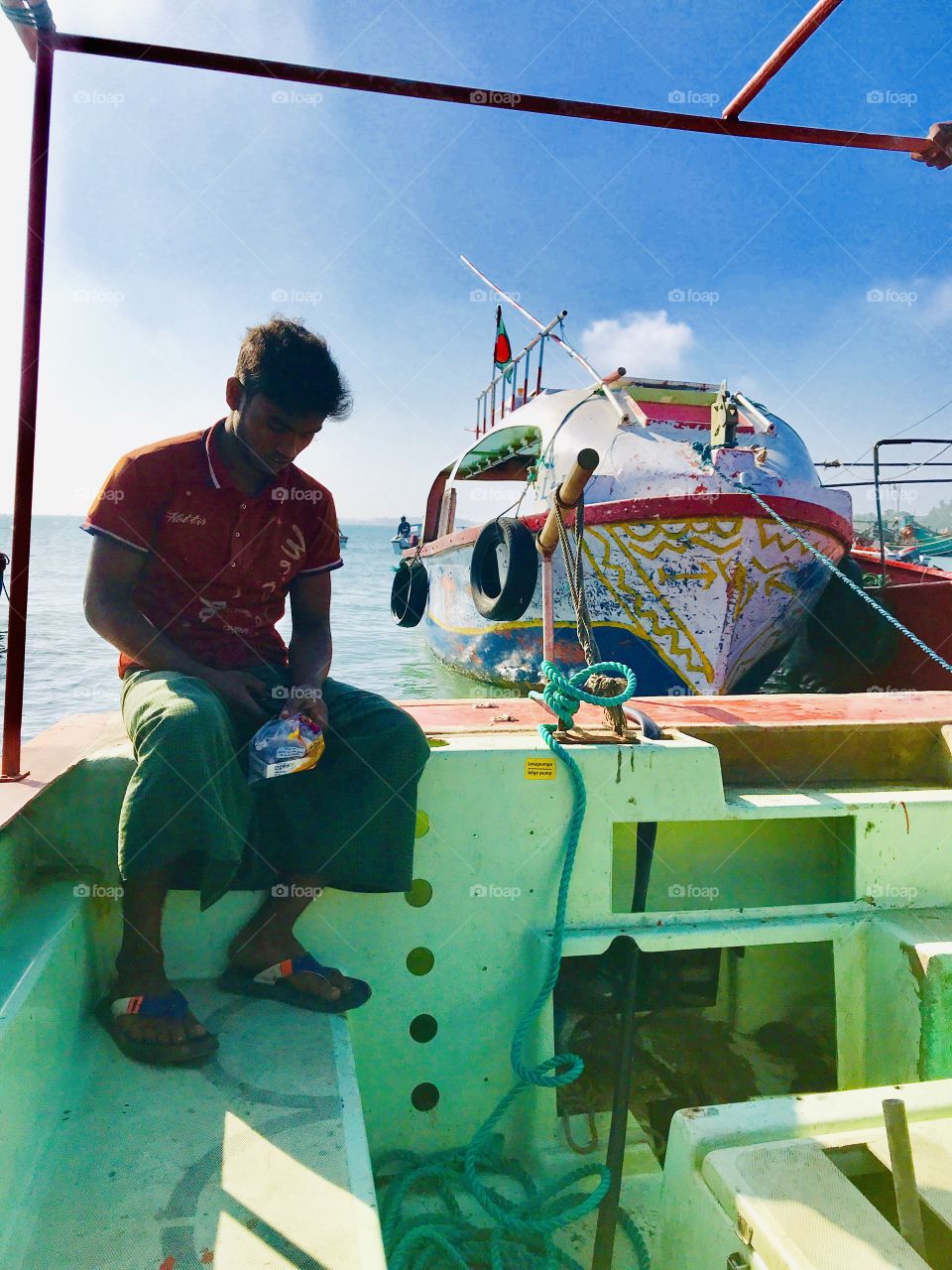 A poor boat man are waiting for travellers to let them from one place to another. They lead their decent life by this pure profession. 