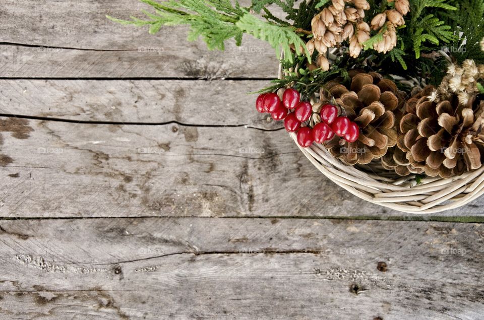 Pine cone and cherry in basket