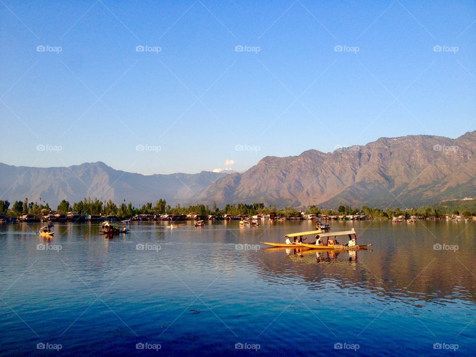 Awesome view of sunset and shikaras - unique boat on Dal lake. Srinagar, Kashmir. 