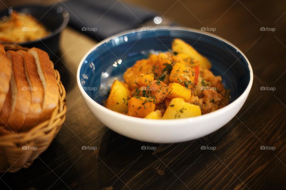 vegetable stew in a blue porcelain plate