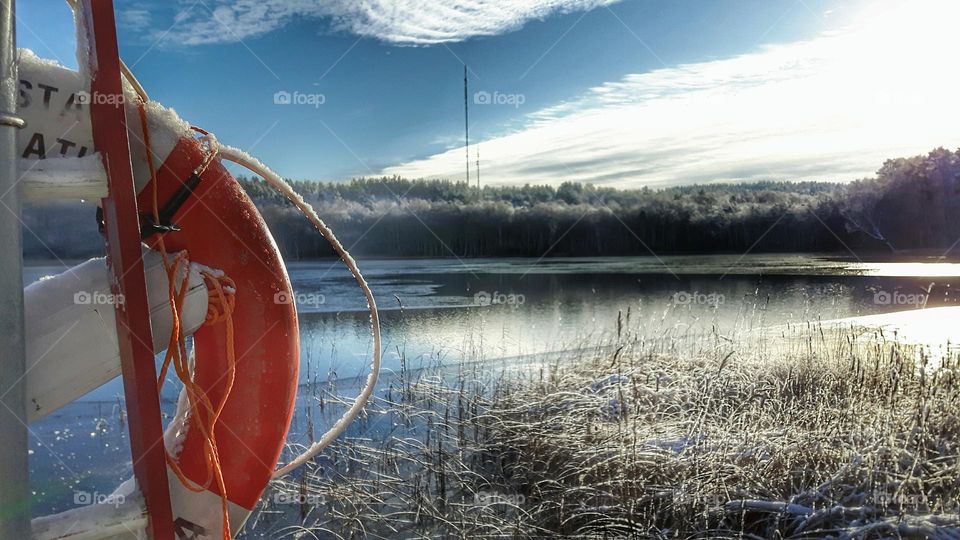 Frosty lake and lifebuoy