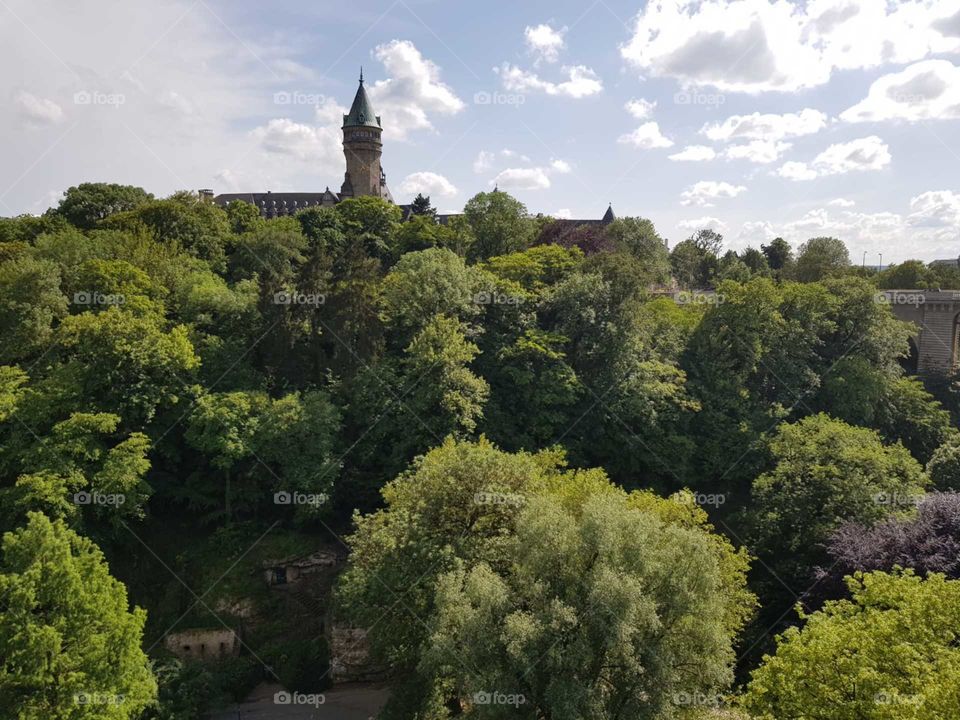 Fantastic view of a castle hidden among the colorful trees of Luxembourg.
