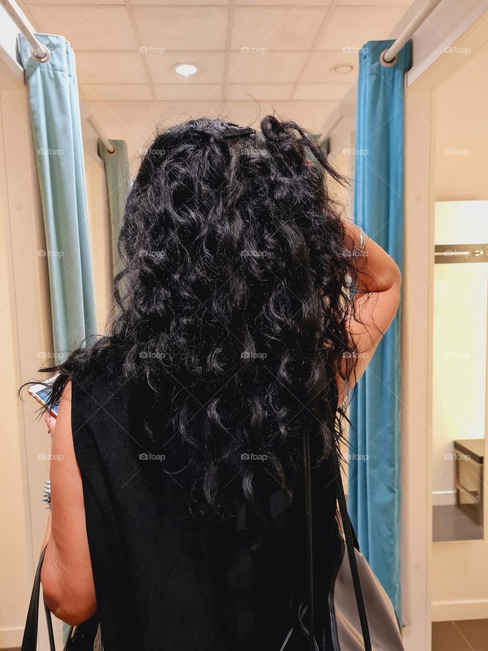 girl from behind with long black curly hair