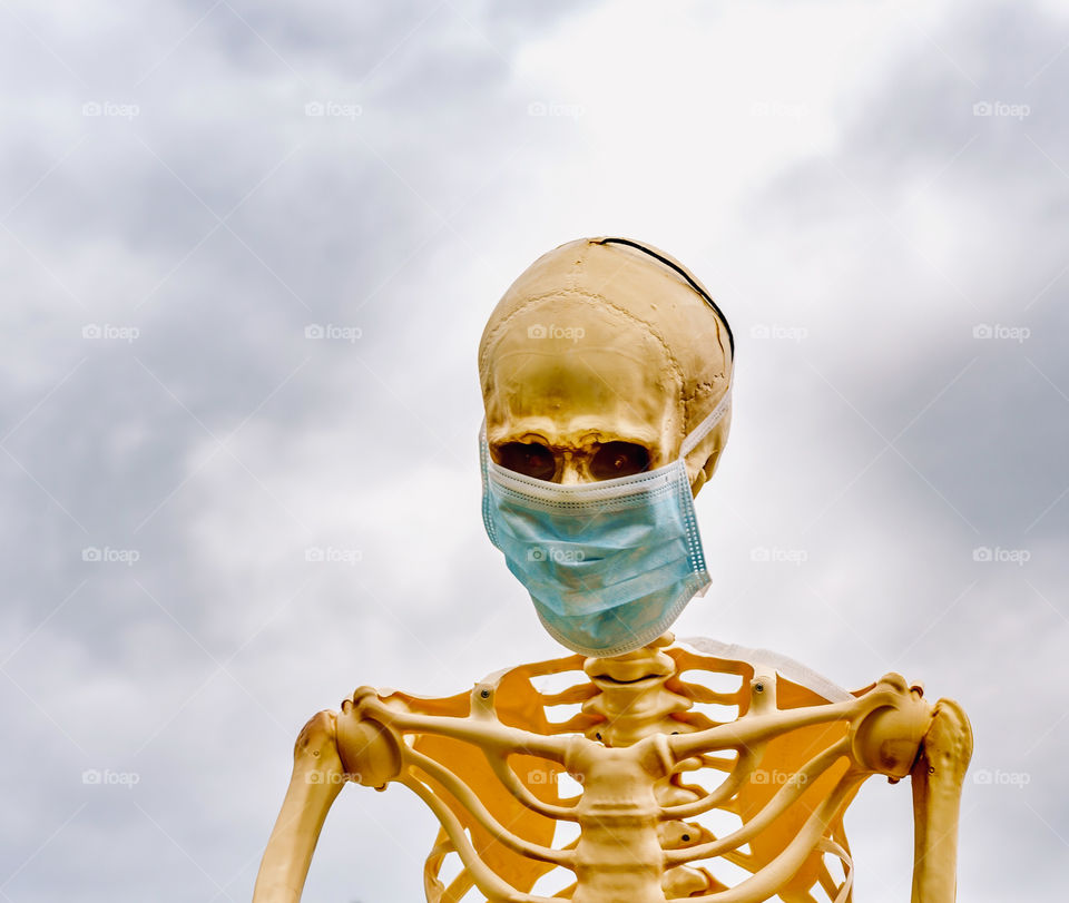 Scary skeleton with mask at Halloween 