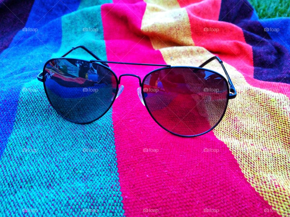 Sunglasses on colored textile fabric