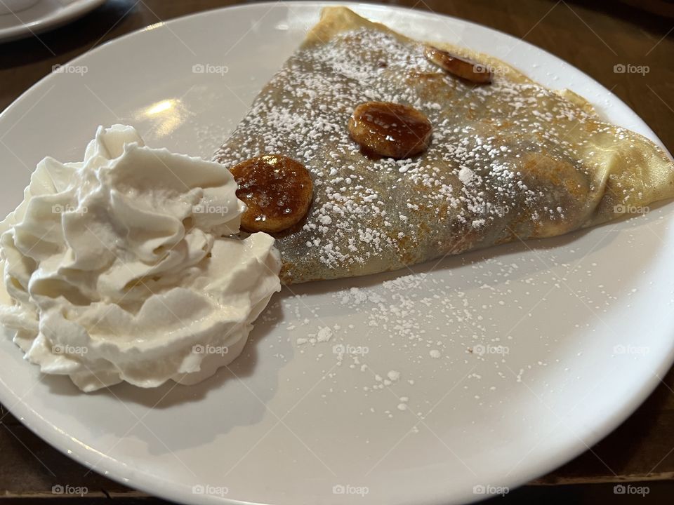 Delicious crepe with banana and whip cream