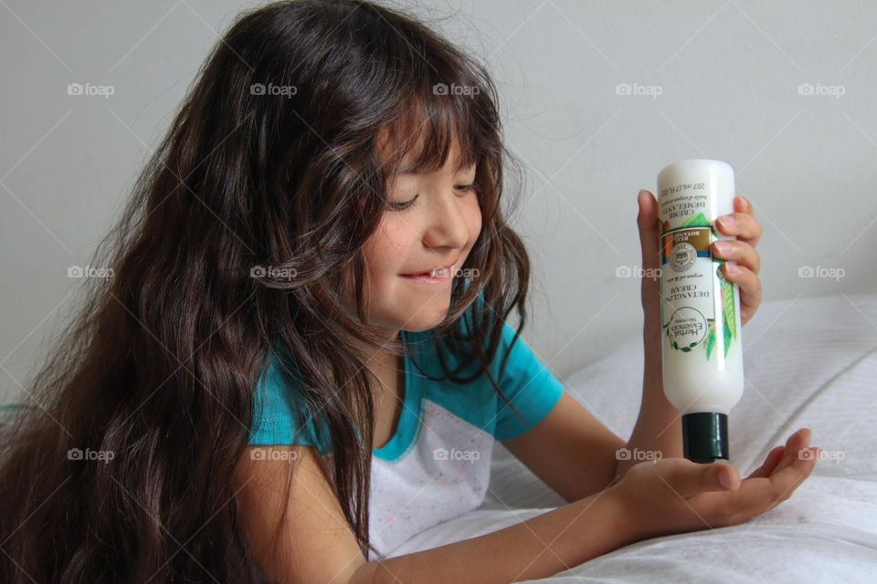 Girl with gorgeous hair is using Herbal Essences product