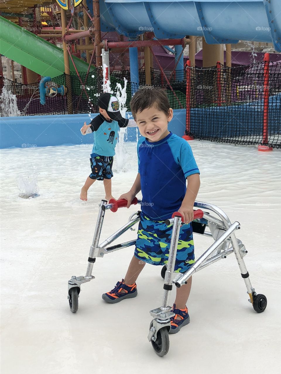 Toddler boy with special needs at water park
