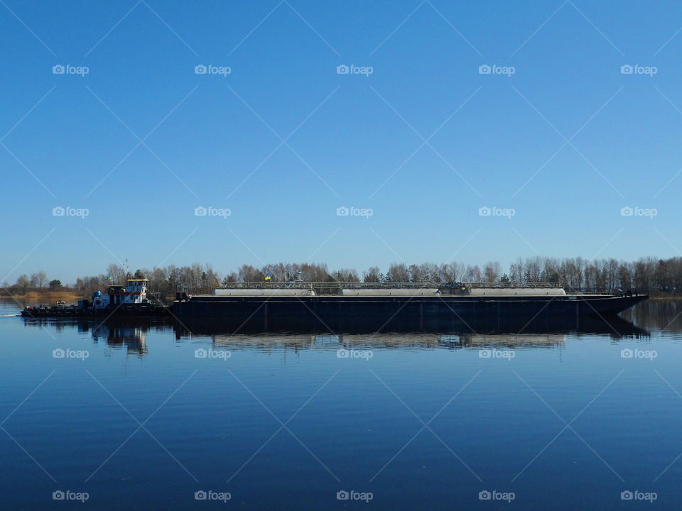 the tugboat sails along the Dnieper River