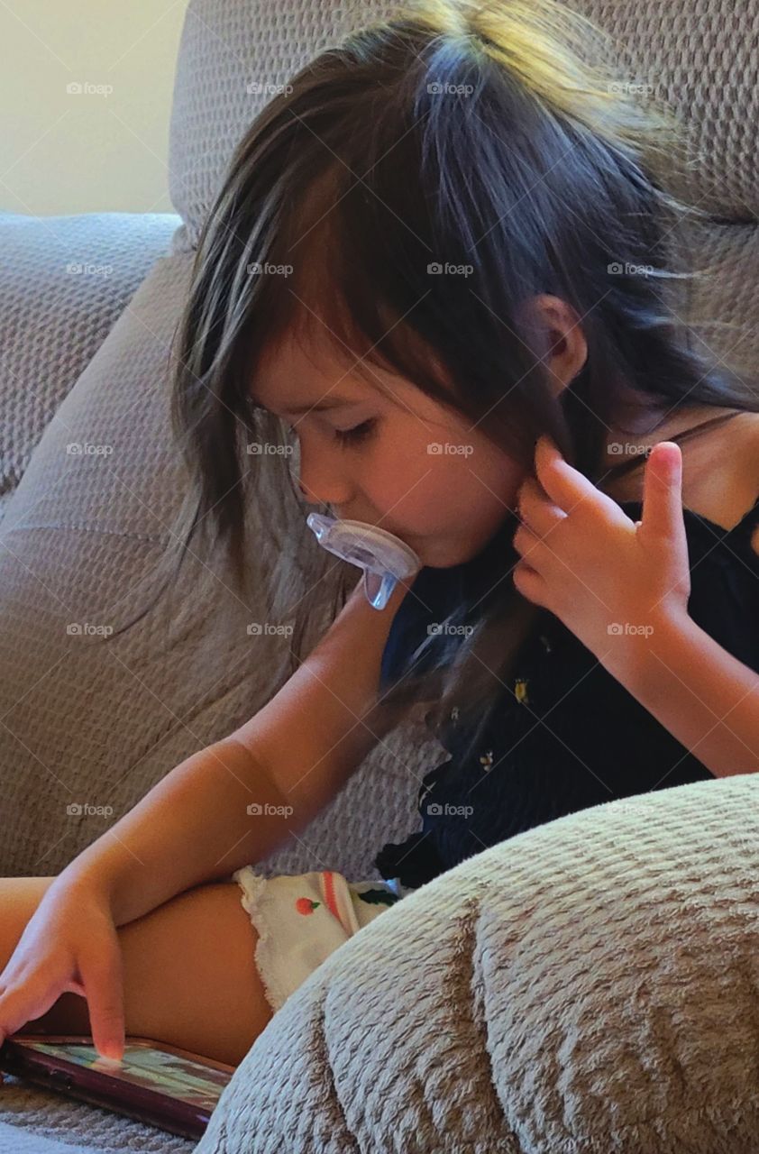 little girl playing games on a cell phone