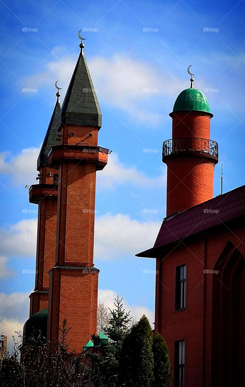 Inam (from Azerbaijani - "Faith") mosque in Moscow against a blue sky with white clouds at sunset