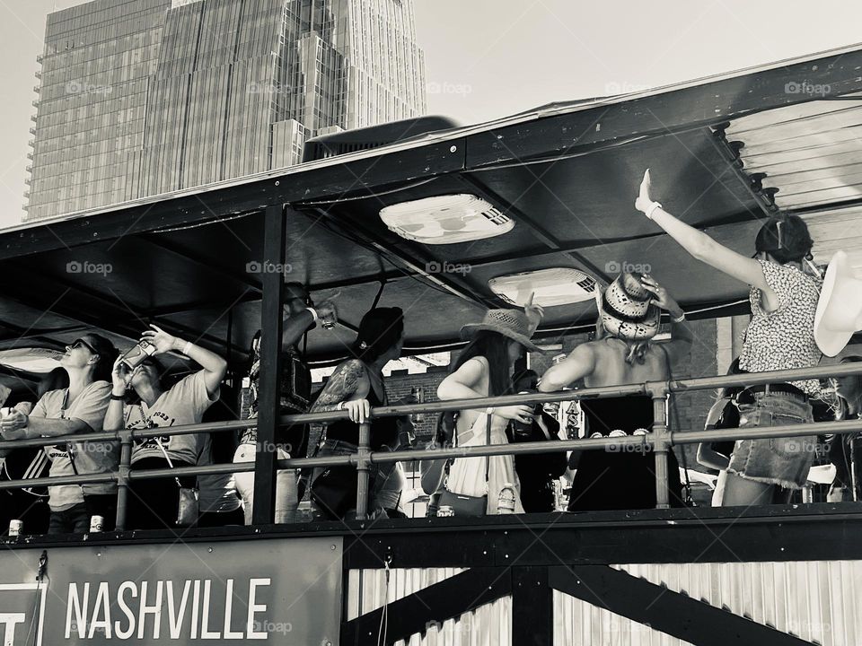 Girls weekend party in Nashville, United States. Women riding a party bus enjoy the revelry on lower Broadway!