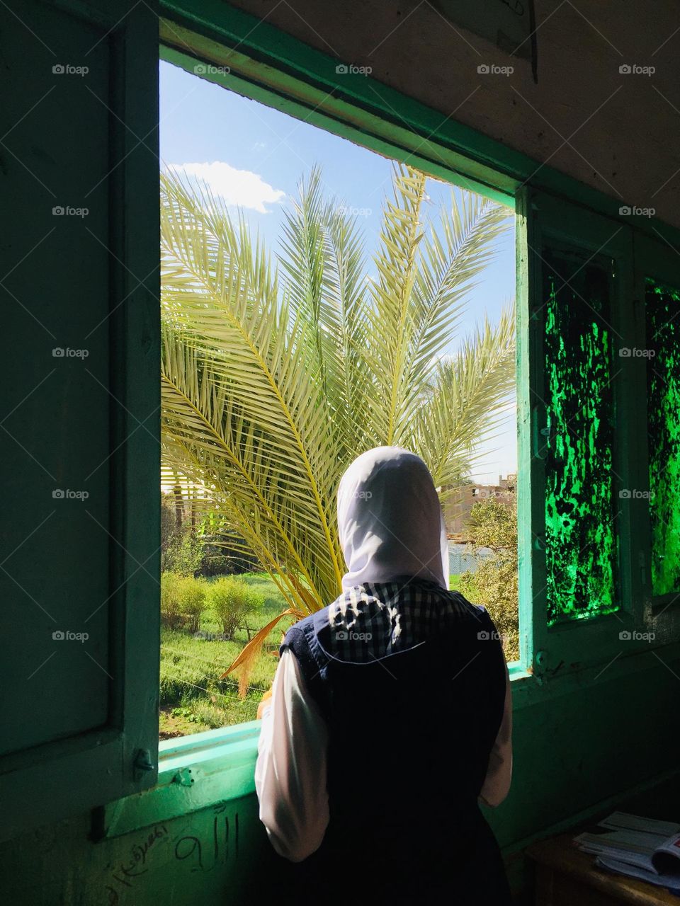 A girl is looking from a window