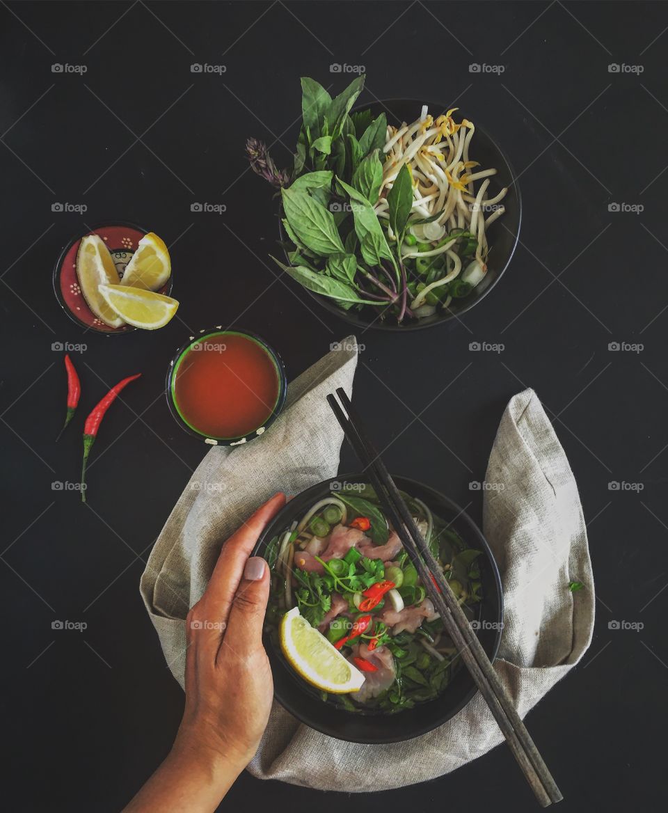 Woman hand holding bowl of food