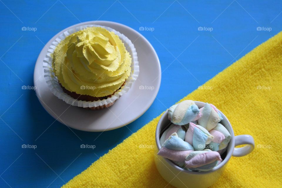 sweets cake and marshmallow yellow and blue background