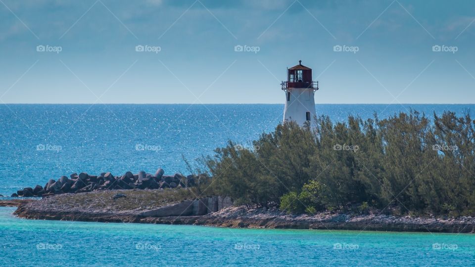 View of lighthouse by sea against sky