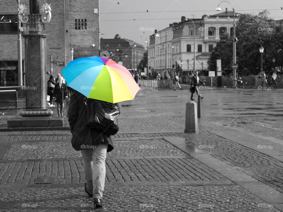The umbrella man ( black and white, only the colour of the umbrella is visible).