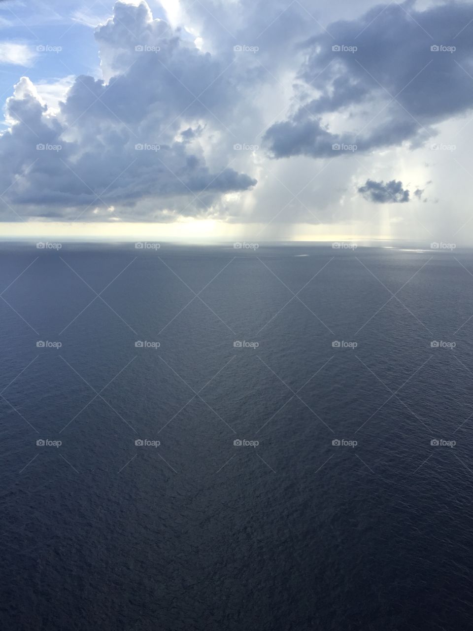 Helicopter view of the Gulf of Mexico with a few scattered showers 
