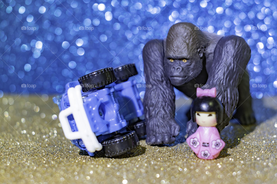 King kong found his lover. a car overturned. shiny background.