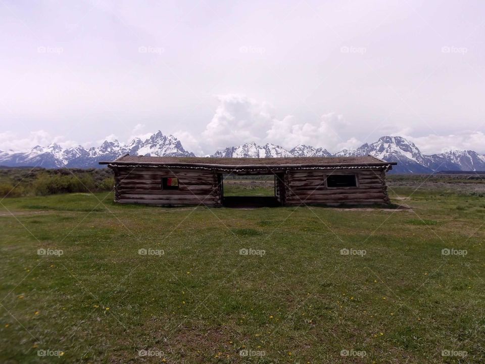 Old cabin built with the view of the mountains 