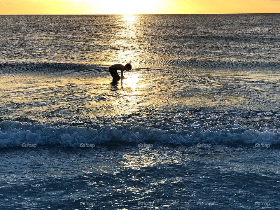 Little boy in the ocean.