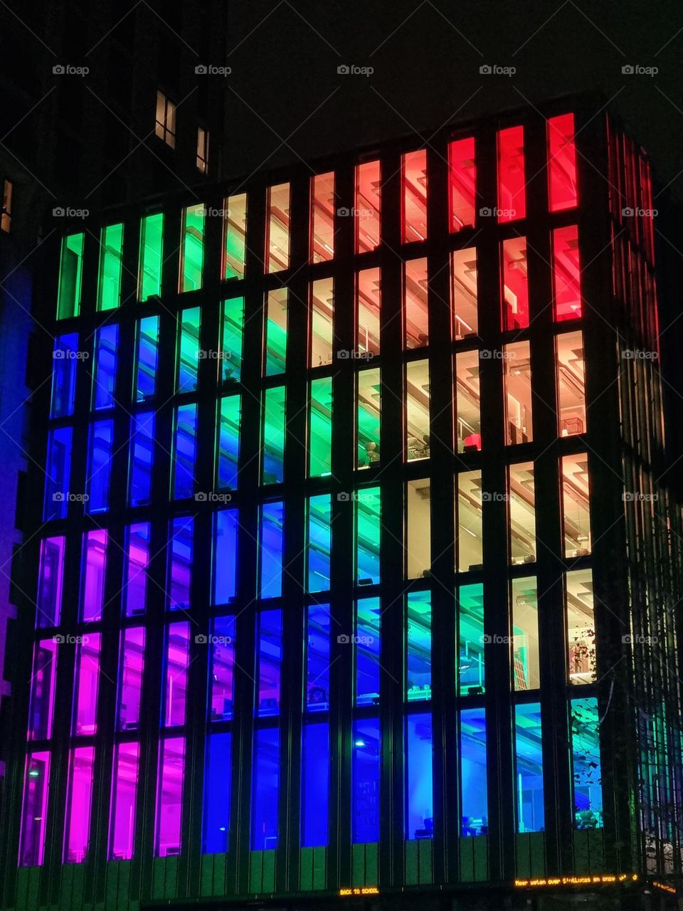 Colored lighting in facade with regular pattern
