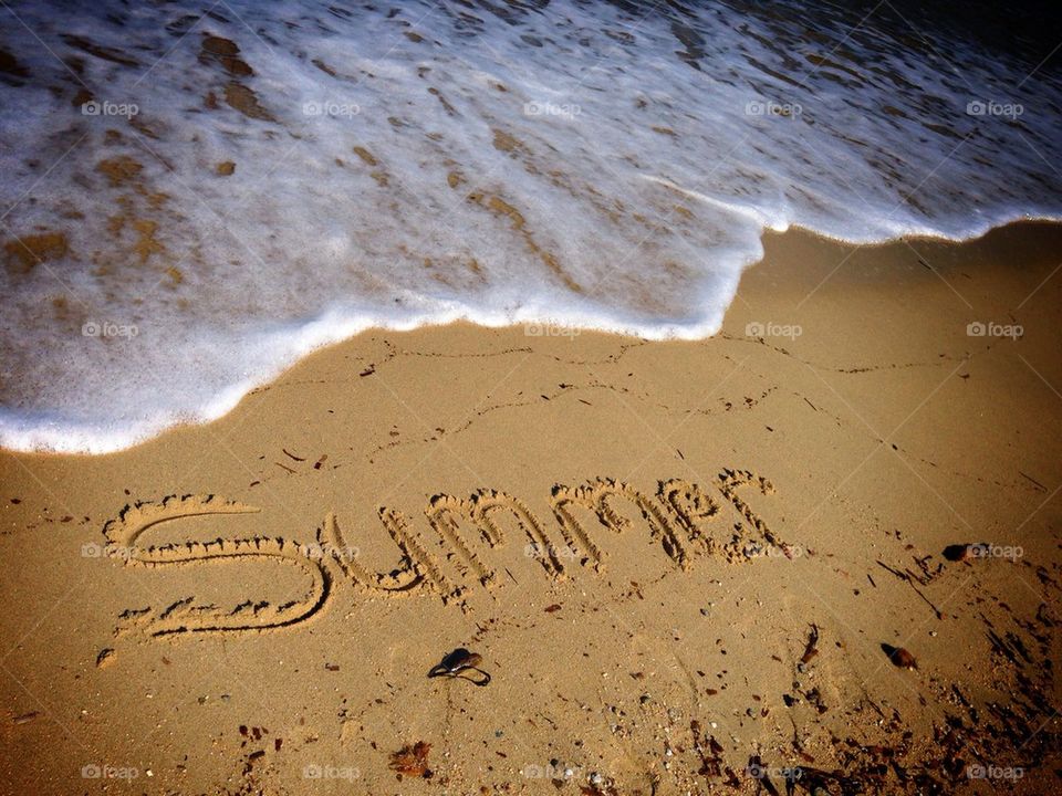Writing "summer" in the sand