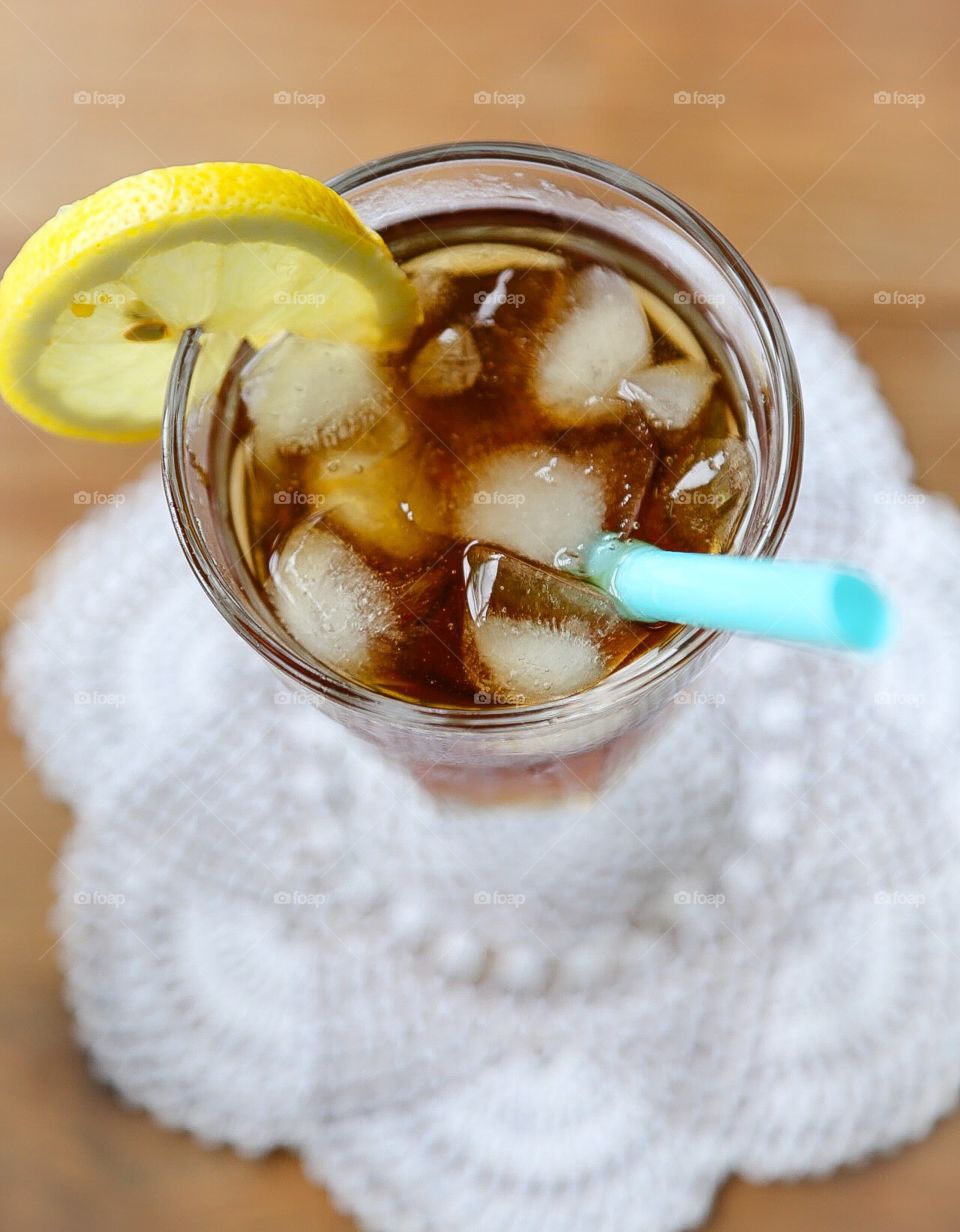 Ice tea. Ice tea with ice cubes and straw 