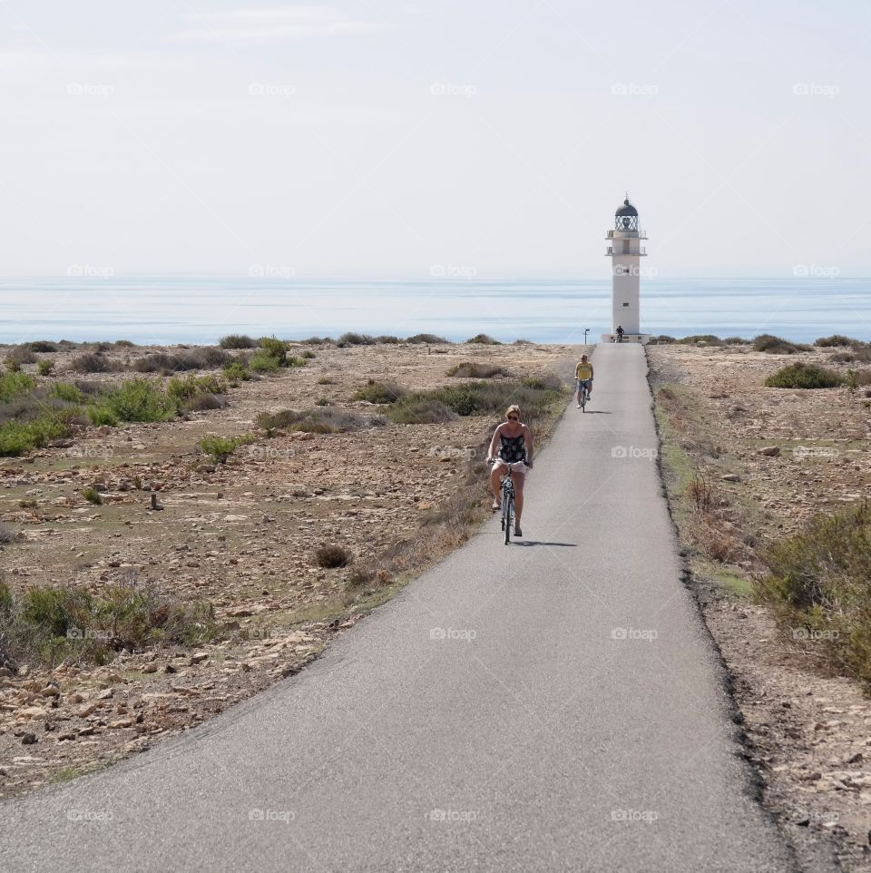 People on bicycles driving from lighthouse 