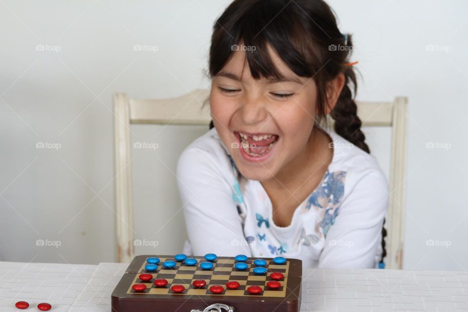 Happy cute girl with M&Ms chocolate