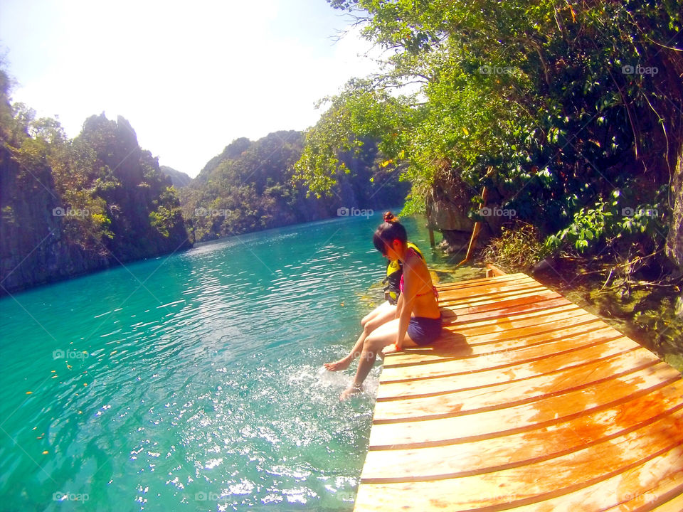 Lady playing with water at Kayangan Lake, Coron Islands, Palawan, Philippines