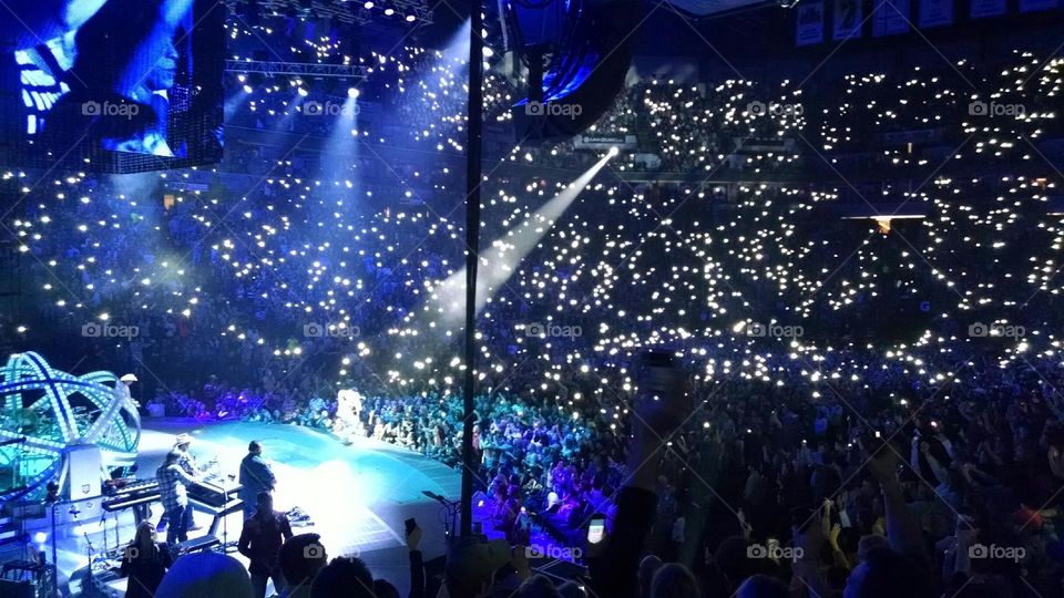 Concert Lights. Fans holding up cell phones during concert.