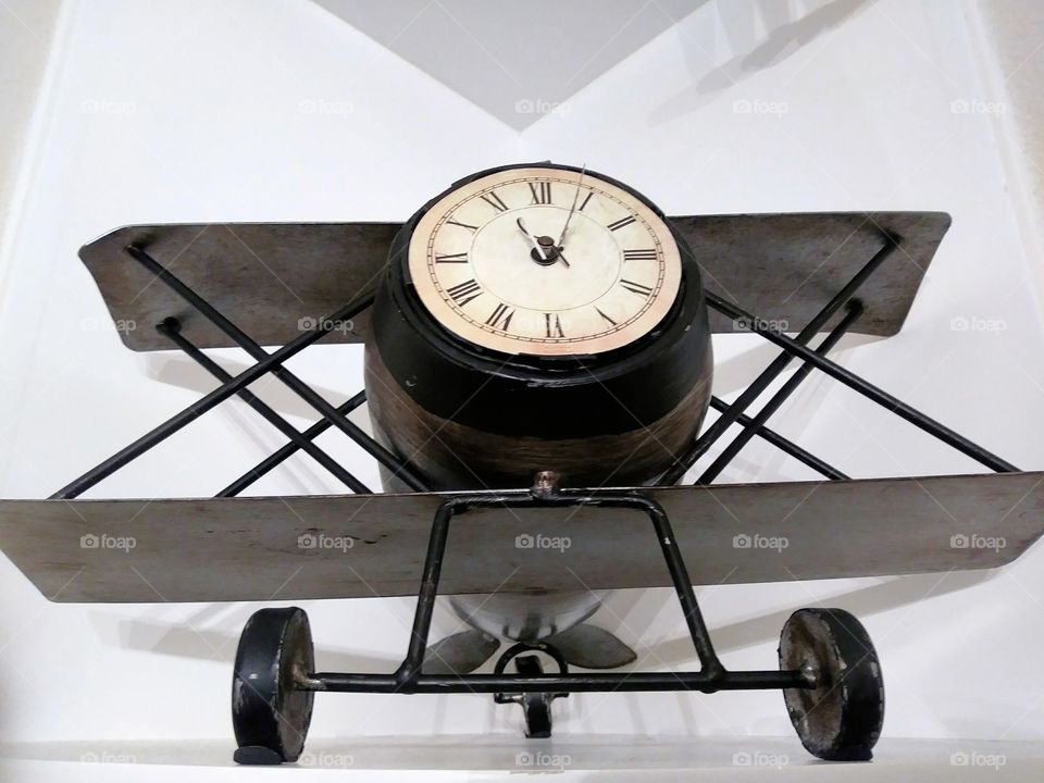 Airplane with a face of a clock, black clock.