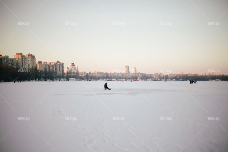 winter.  man is fishing in nature in winter.  the lake is freezing