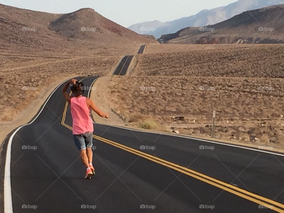 Runner cowboy on the road