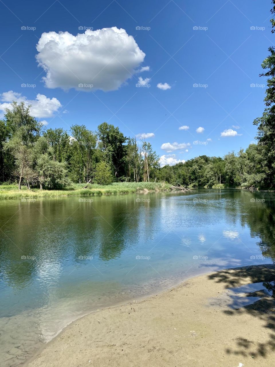 water landscape grass and clouds