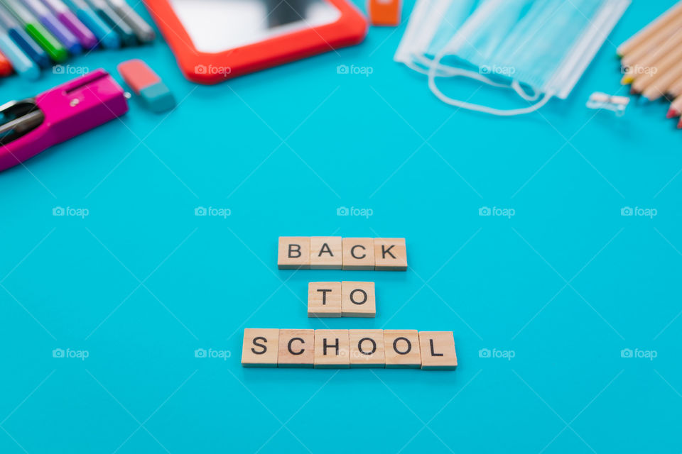 Set of school items with “Back to school” lettering on a blue background. Back to school concept. Copy space