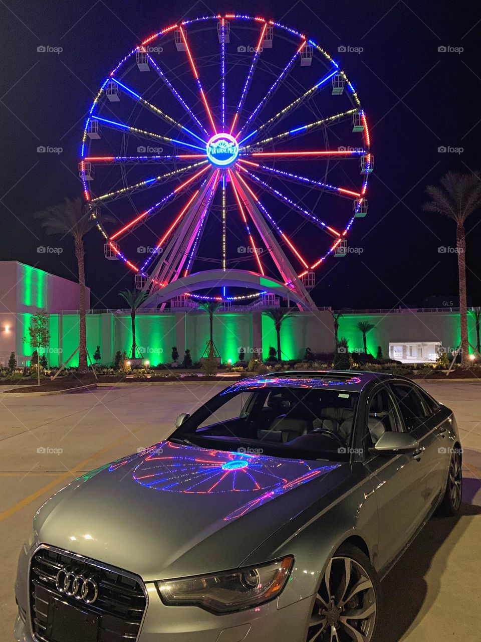 Cars with soul - 2014 Audi A6 4dr Sdn quattro 3.0L TDI Premium Plus with a reflection from a colorful Ferris Wheel 