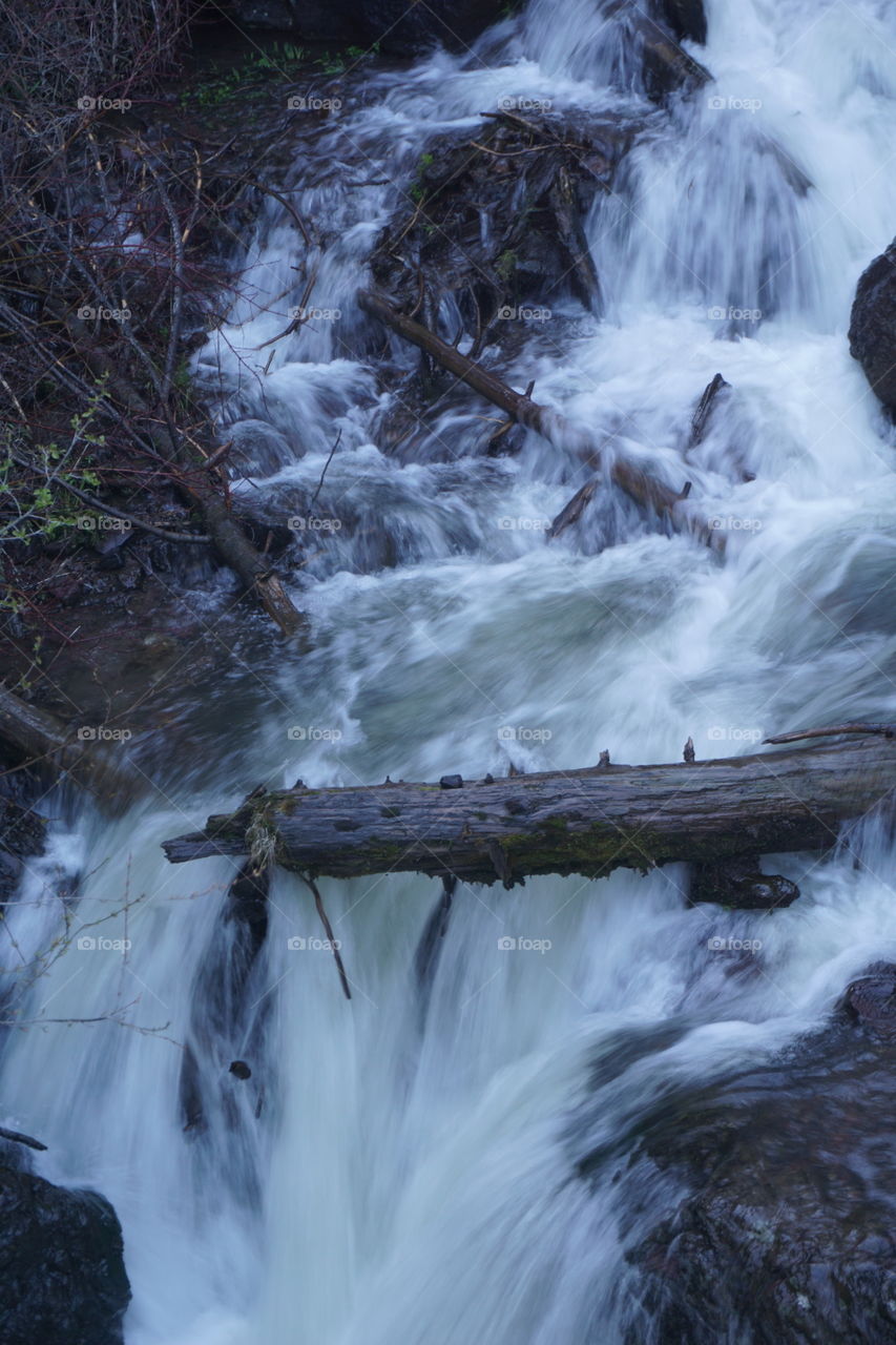 Log in a waterfall