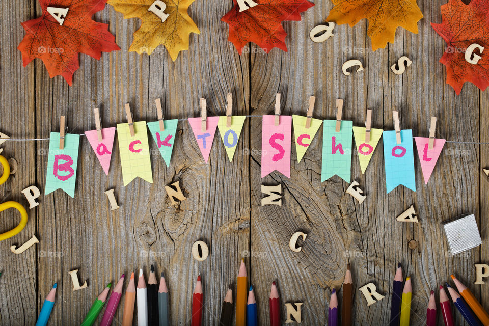 Back to school garland background. Pencils, letters on the wooden surface