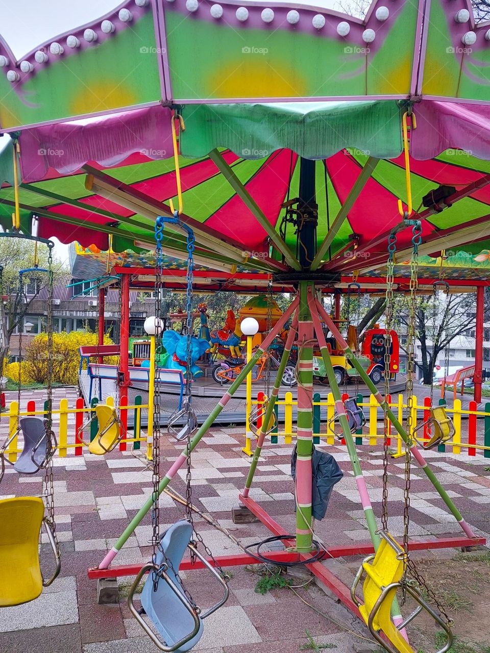 Colorful carousel in the children's amusement park.  Dominance geometric shapes: triangle,  rectangle, and circles