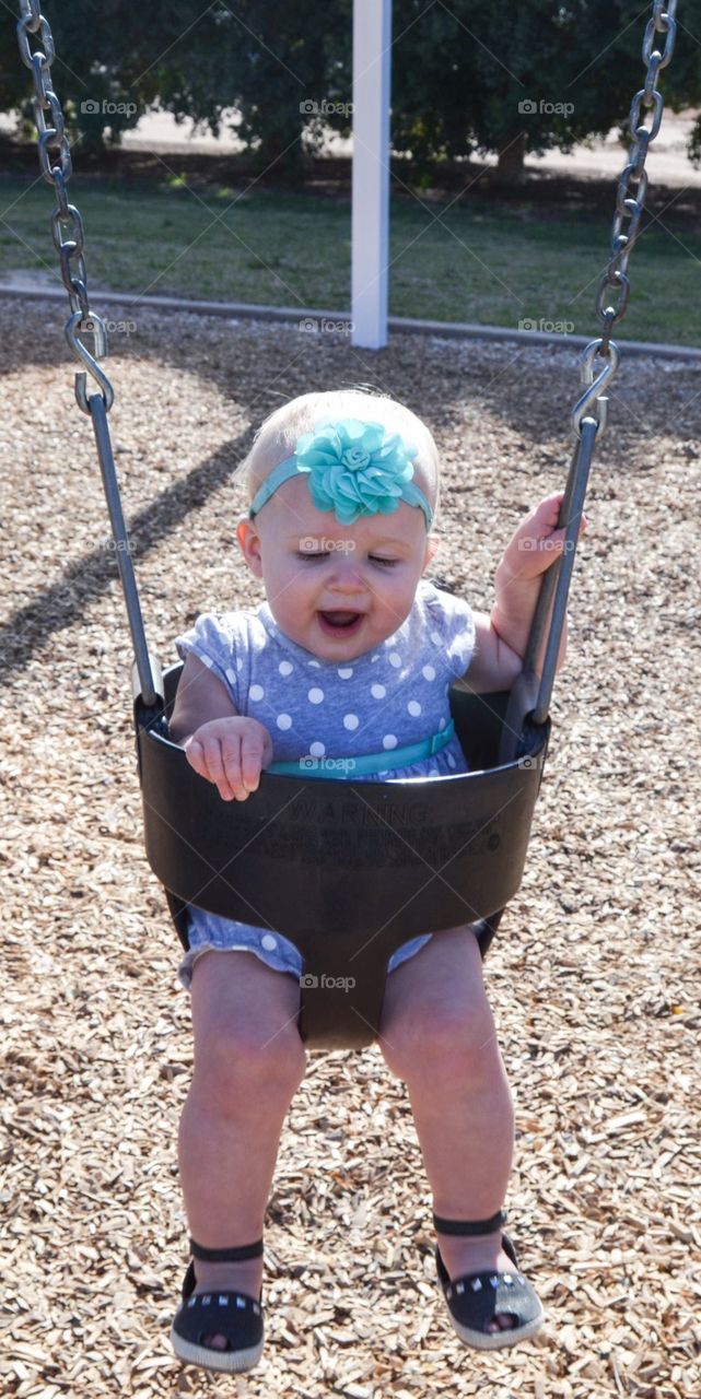 Baby girl in a swing