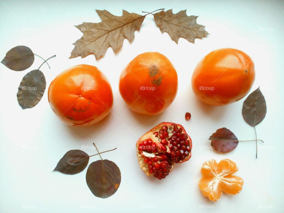 Fruits and tomato on white background