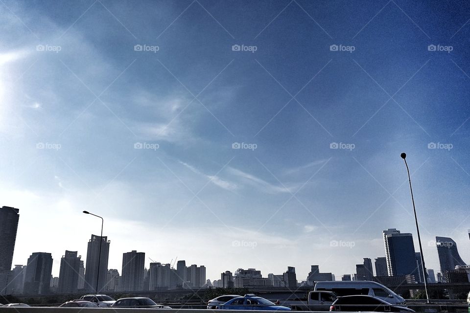 busy traffic in the city buildings landscape and sky in the evening