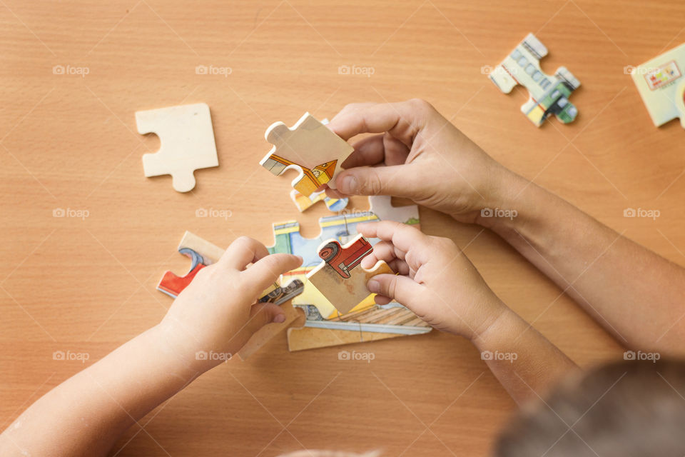 High angle view of human hand with puzzle pieces